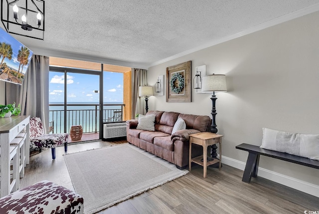 6900 N Ocean Blvd Unit 1437, Myrtle Beach, SC 29572 - living room with a textured ceiling, a water view, a chandelier, crown molding, and wood finished floors