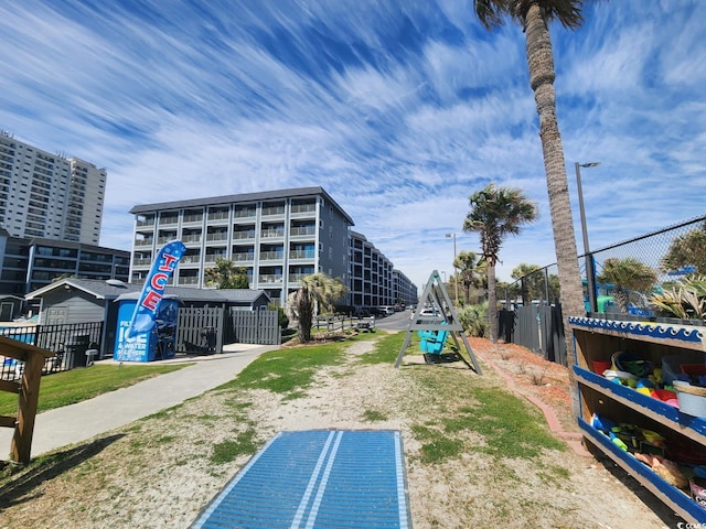 view of home's community with fence