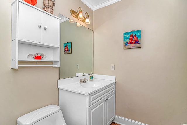 bathroom featuring ornamental molding, vanity, and toilet