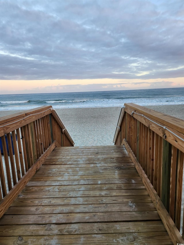 view of home's community featuring view of water and beach