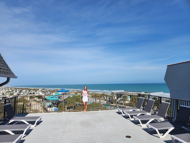 view of patio / terrace featuring a water view and a balcony