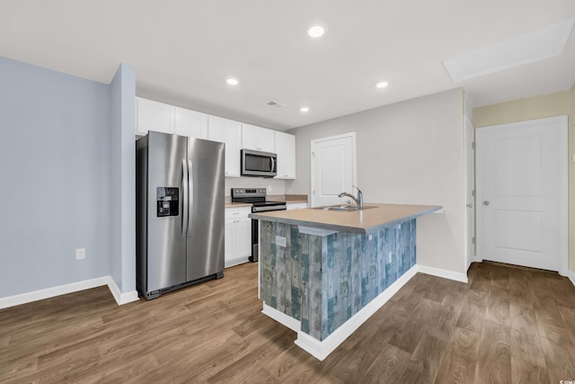 478 Samara Dr, Longs, SC 29568 - kitchen with appliances with stainless steel finishes, a sink, baseboards, wood finished floors, and recessed lighting