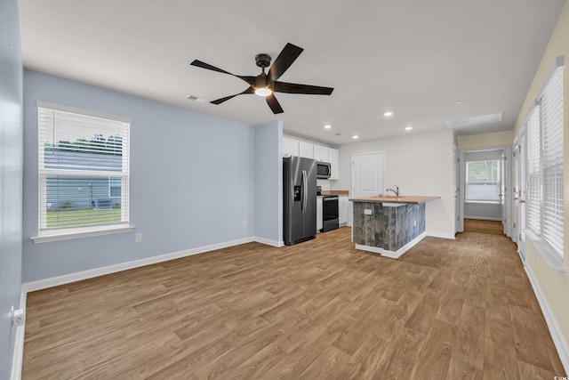 478 Samara Dr, Longs, SC 29568 - kitchen with stainless steel appliances, white cabinetry, light wood-type flooring, baseboards, and ceiling fan