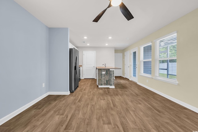 478 Samara Dr, Longs, SC 29568 - unfurnished living room with baseboards, wood finished floors, ceiling fan, recessed lighting, and a sink