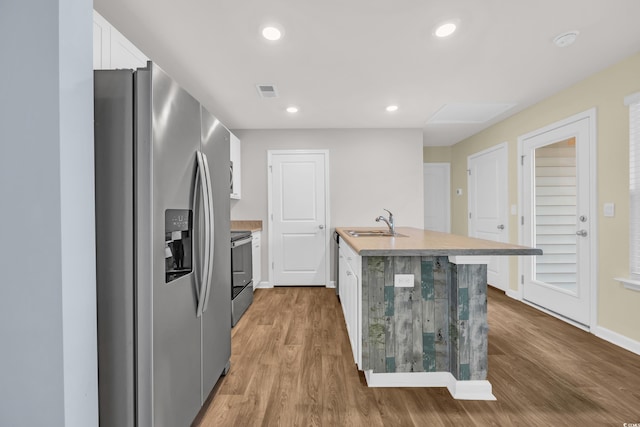 478 Samara Dr, Longs, SC 29568 - kitchen with stainless steel refrigerator with ice dispenser, a sink, electric range, white cabinetry, and wood finished floors