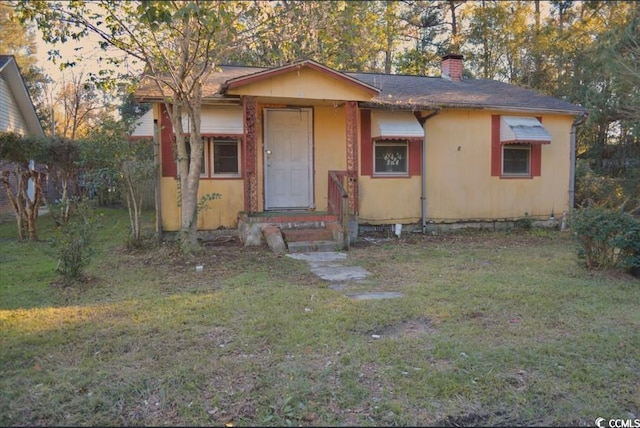 414 E Wine St, Mullins, SC 29574 - bungalow-style home with a front lawn and a chimney