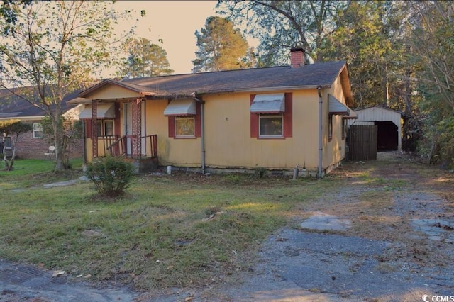 414 E Wine St, Mullins, SC 29574 - view of front of house with a chimney and a front lawn