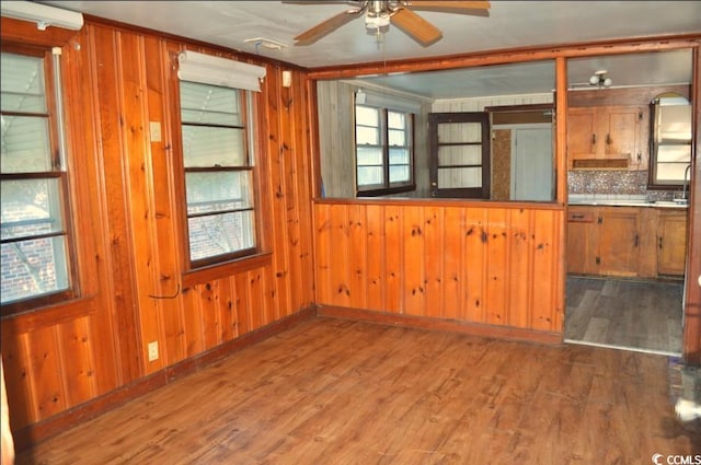 414 E Wine St, Mullins, SC 29574 - spare room with ceiling fan, wood finished floors, and wooden walls
