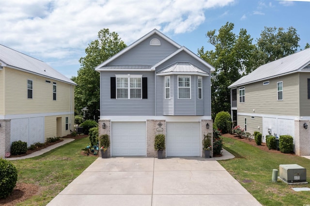 view of front of property featuring concrete driveway, a front lawn, an attached garage, brick siding, and metal roof