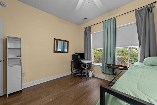bedroom with dark wood-style floors, baseboards, a desk, and a ceiling fan