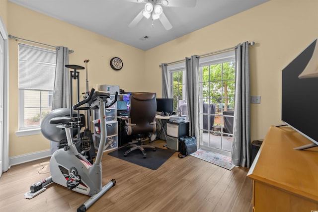 home office featuring ceiling fan, wood finished floors, and plenty of natural light