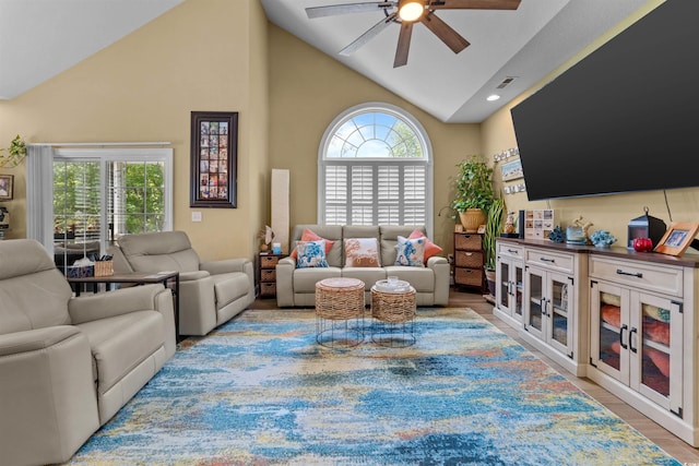 living room featuring a ceiling fan, high vaulted ceiling, light wood-style floors, and recessed lighting