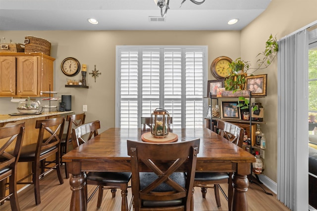 dining room featuring light wood finished floors and recessed lighting