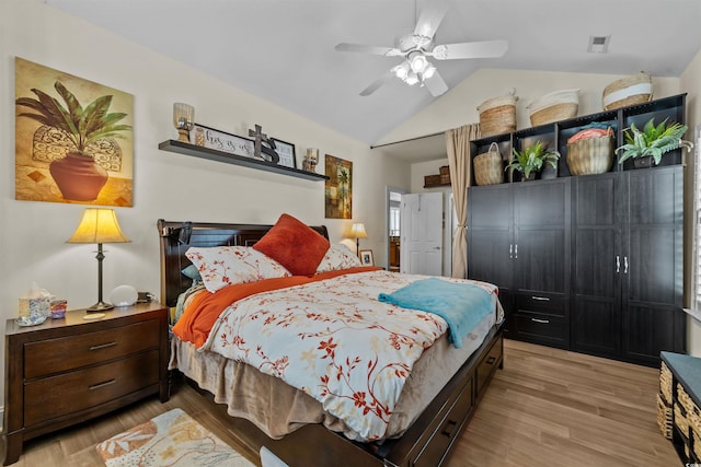 bedroom with vaulted ceiling, light wood-style floors, and a ceiling fan