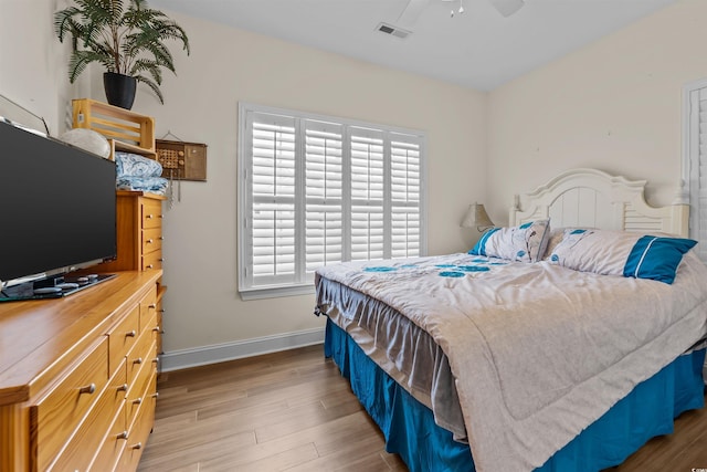 bedroom featuring light wood-style flooring and baseboards