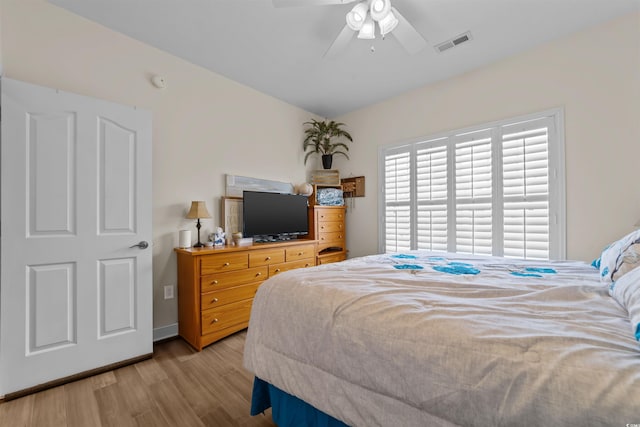 bedroom with light wood-type flooring and a ceiling fan