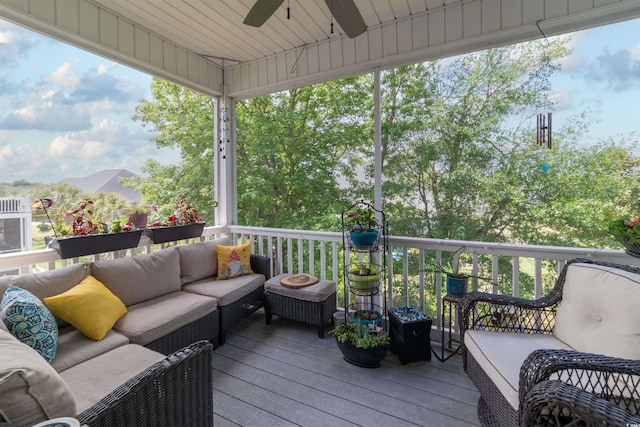 deck with an outdoor living space and a ceiling fan