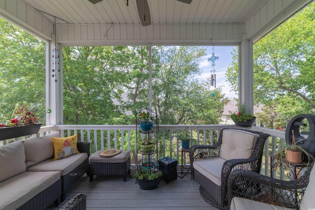 deck with outdoor lounge area and ceiling fan