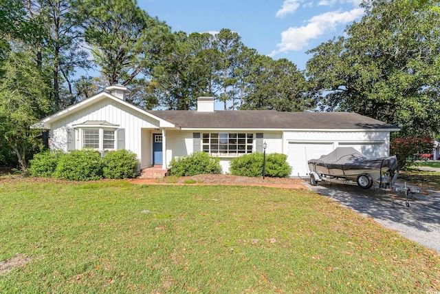 2604 S Bay St, Georgetown, SC 29440 - single story home with a garage, a front lawn, asphalt driveway, and a chimney