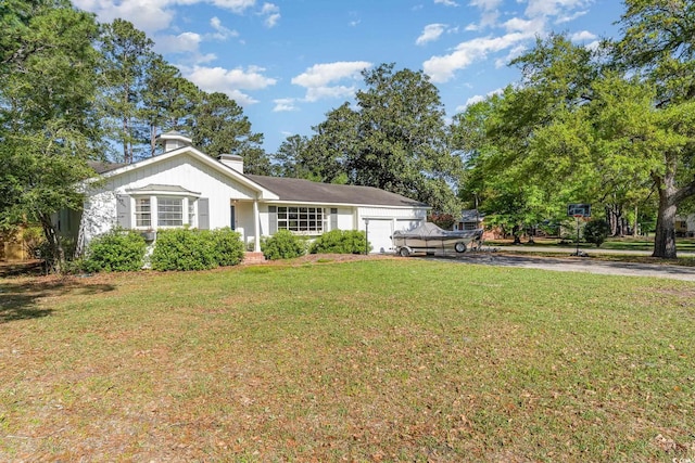 2604 S Bay St, Georgetown, SC 29440 - view of front of house with a garage, asphalt driveway, a front yard, and a chimney