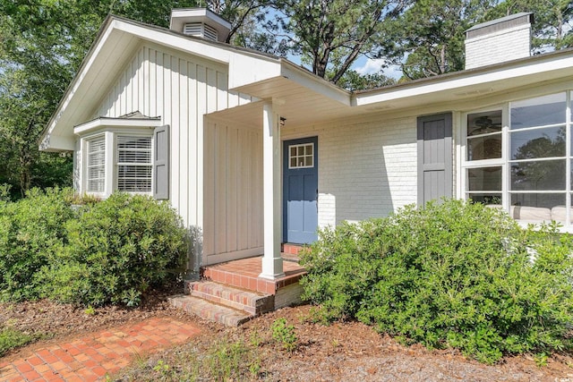 2604 S Bay St, Georgetown, SC 29440 - property entrance with a chimney, board and batten siding, and brick siding