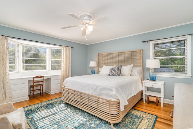 2604 S Bay St, Georgetown, SC 29440 - bedroom with wood finished floors, multiple windows, ornamental molding, ceiling fan, and baseboards