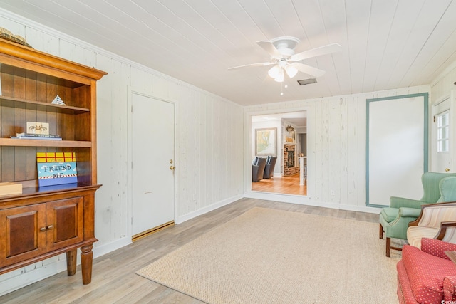 2604 S Bay St, Georgetown, SC 29440 - sitting room featuring wood finished floors, ceiling fan, ornamental molding, wood walls, and baseboards