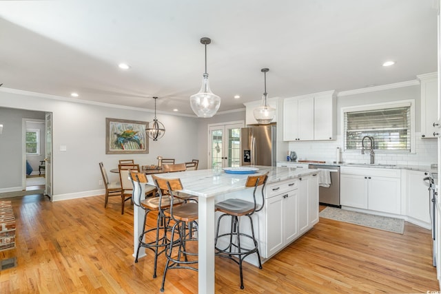 2604 S Bay St, Georgetown, SC 29440 - kitchen with appliances with stainless steel finishes, crown molding, a sink, recessed lighting, and light stone countertops