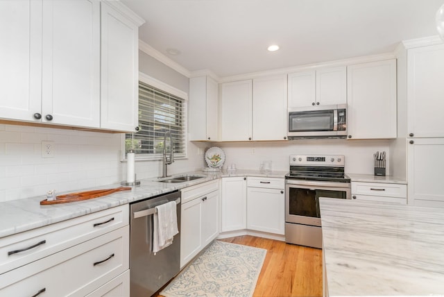 2604 S Bay St, Georgetown, SC 29440 - kitchen featuring stainless steel appliances, a sink, white cabinetry, decorative backsplash, and recessed lighting