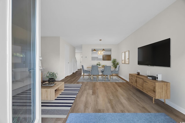 living room featuring wood finished floors and baseboards