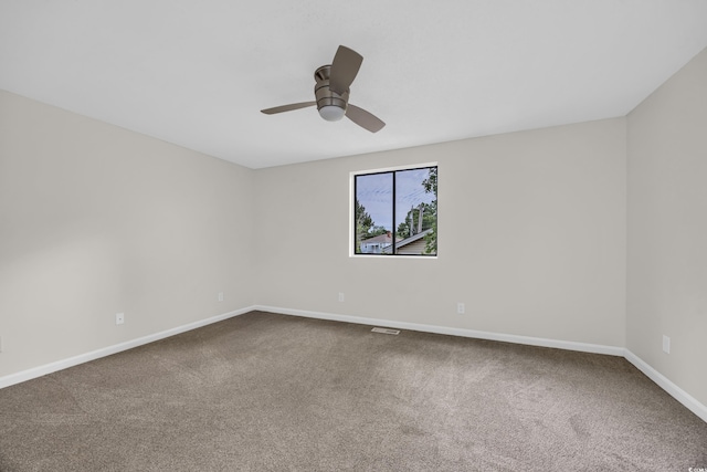 spare room featuring carpet flooring, a ceiling fan, and baseboards