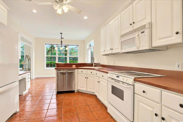 154 Windsor Cir SW, Ocean Isle Beach, NC 28469 - kitchen featuring white appliances, a sink, white cabinetry, and recessed lighting