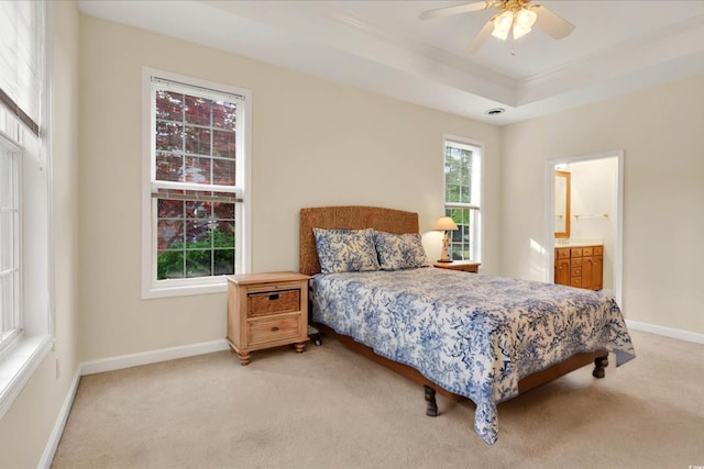 154 Windsor Cir SW, Ocean Isle Beach, NC 28469 - bedroom with light carpet, baseboards, a raised ceiling, crown molding, and ensuite bath