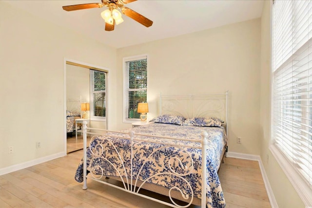 154 Windsor Cir SW, Ocean Isle Beach, NC 28469 - bedroom featuring hardwood / wood-style flooring, multiple windows, and baseboards