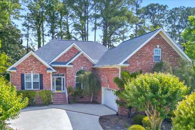 154 Windsor Cir SW, Ocean Isle Beach, NC 28469 - view of front facade featuring driveway and brick siding