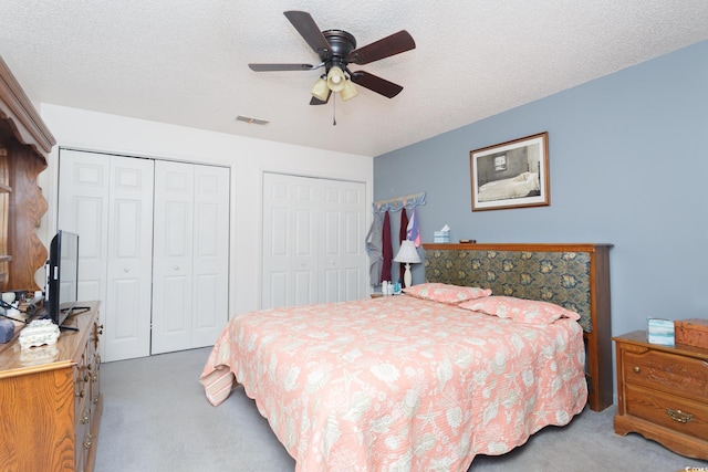 510 Fairwood Lakes Dr Unit 17-P, Myrtle Beach, SC 29588 - bedroom featuring carpet, multiple closets, ceiling fan, and a textured ceiling