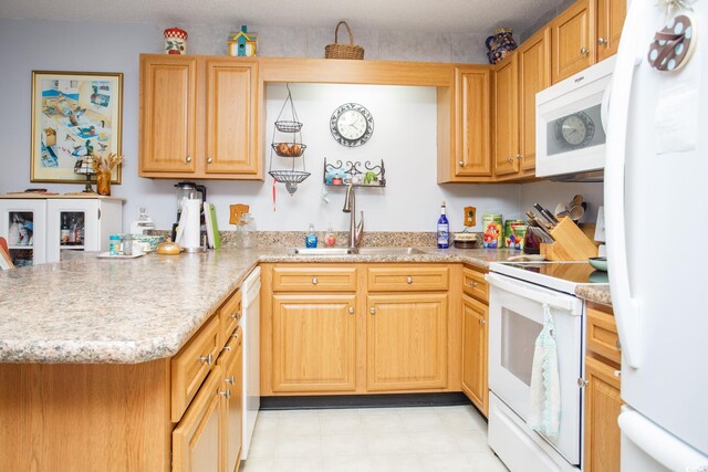 510 Fairwood Lakes Dr Unit 17-P, Myrtle Beach, SC 29588 - kitchen featuring white appliances, a sink, a peninsula, and light stone counters