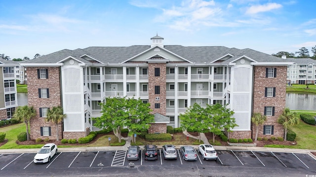 4887 Luster Leaf Cir Unit 105, Myrtle Beach, SC 29577 - view of building exterior with uncovered parking