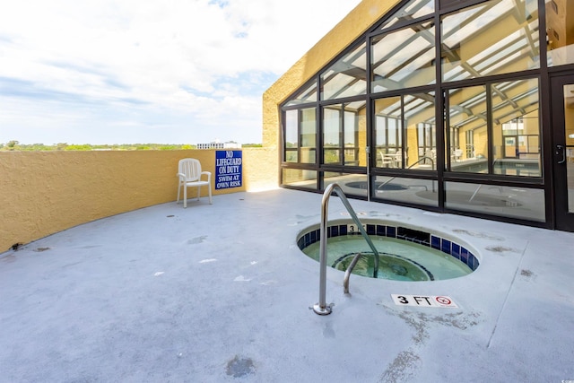 view of swimming pool with an in-ground hot tub
