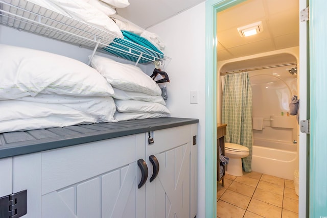 bathroom with toilet, tile patterned flooring, shower / bath combination with curtain, and vanity