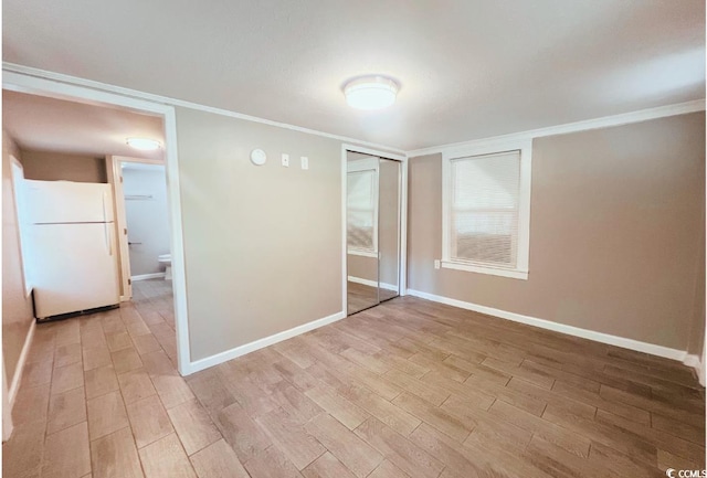 401 Alder St, Myrtle Beach, SC 29577 - empty room featuring light wood-style floors, baseboards, and ornamental molding