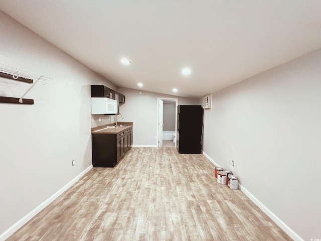 401 Alder St, Myrtle Beach, SC 29577 - bar featuring white microwave, light wood-type flooring, recessed lighting, baseboards, and a sink