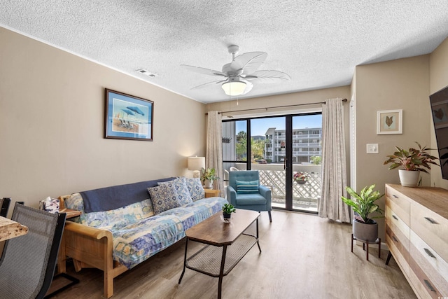 625 N Waccamaw Dr Unit 107, Murrells Inlet, SC 29576 - living area with light wood-style flooring, a textured ceiling, and ceiling fan