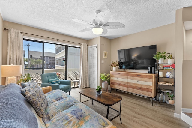 625 N Waccamaw Dr Unit 107, Murrells Inlet, SC 29576 - living room featuring wood finished floors, ceiling fan, a textured ceiling, and baseboards