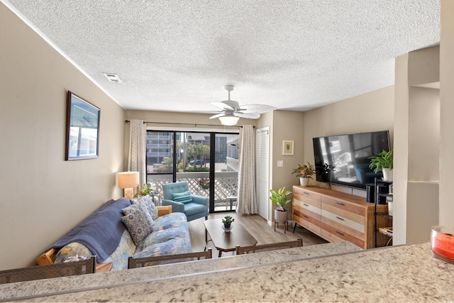 625 N Waccamaw Dr Unit 107, Murrells Inlet, SC 29576 - living area with wood finished floors, a ceiling fan, and a textured ceiling