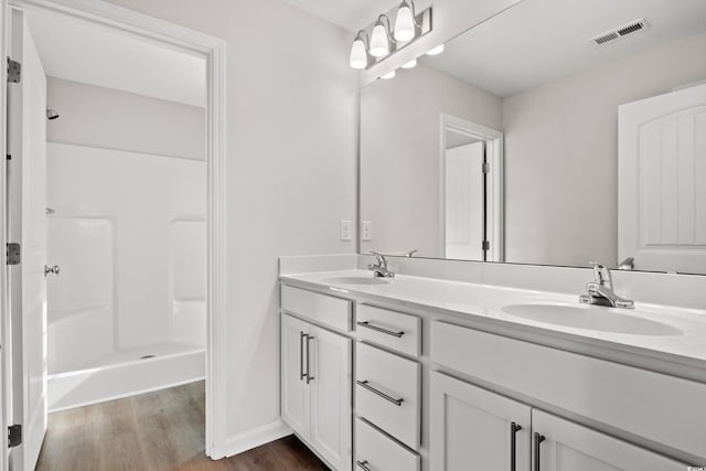 154 Six Mile Creek Dr, Georgetown, SC 29440 - bathroom with double vanity, wood finished floors, a shower, and baseboards