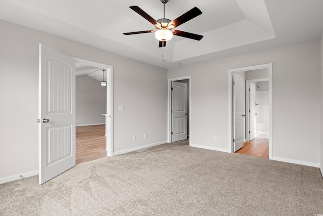 154 Six Mile Creek Dr, Georgetown, SC 29440 - unfurnished bedroom featuring carpet, a tray ceiling, baseboards, and ceiling fan