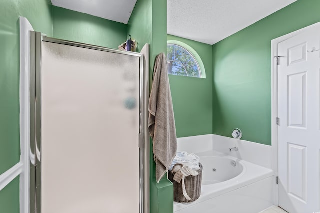 bathroom featuring a whirlpool tub and a stall shower