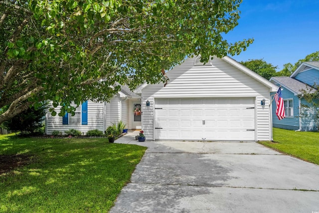 view of front of property with concrete driveway, a front yard, and an attached garage