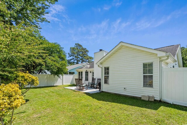rear view of property with a patio area and a chimney
